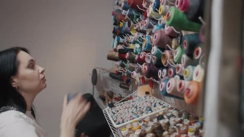 Woman Selecting Colorful Thread in Bright Studio