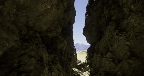 Rocky Crevice Revealing Desert Landscape Under Bright Sun
