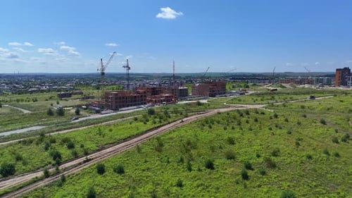 Wide Panoramic View of a Construction Site with Cranes Concept of Construction of a Residential