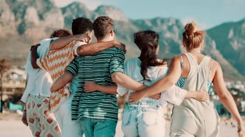 Friends, back and walking on beach with hug for bonding, support and wind for vacation