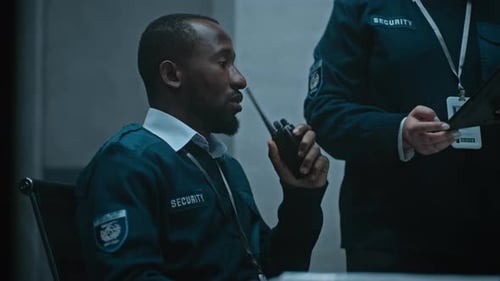 Man in Security Uniform Talking into Walkie Talkie