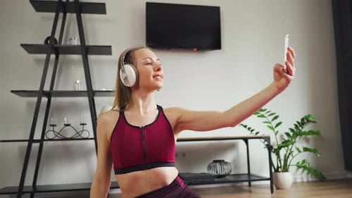 Woman Dancing with Smartphone Wearing Headphones