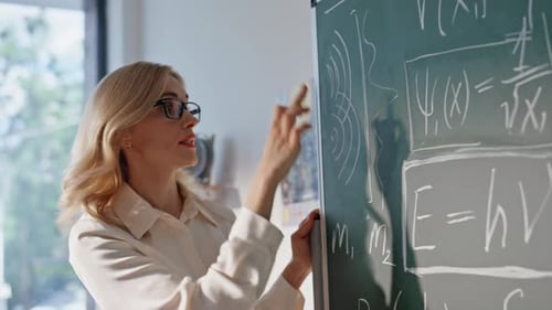 Woman Explains Math Equations on Chalkboard