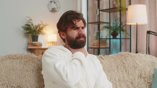 Adult Man with Sore Throat in Living Room