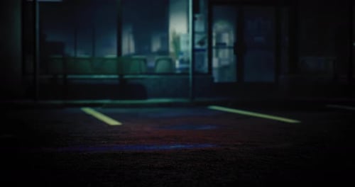 Empty Parking Lot at Night with Eerie Lighting and Shadows