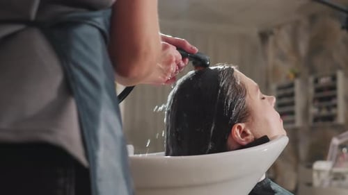 Woman Getting her Hair Washed at Hair Salon