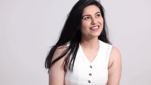 Smiling Woman Poses With Confidence In Bright Studio
