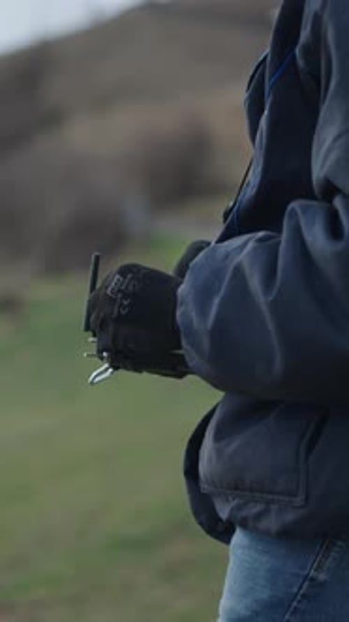 Adult operating a drone in the countryside