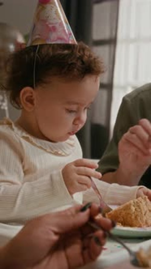 Baby Girl Celebrates First Birthday Eating Cake