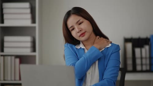 Businesswoman is seriously stressed working feel Shoulder pain and backache due to office syndrome