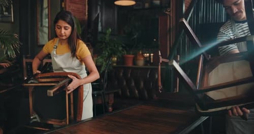 Cafe, waiters and prepare table for opening, organize furniture or teamwork in small business