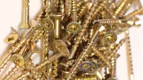 Yellow Metal Screws Rotate in a Circle Fasteners When Working with Wood and Plasterboard Vertical