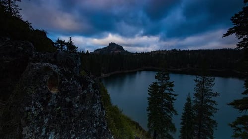 Motion time lapse of a mountain and lake.