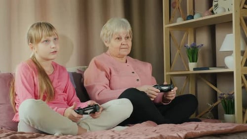 Grandchild and Grandmother Playing Video Games at Home