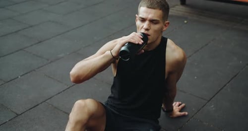 Man Drinking Water After Workout Outdoors