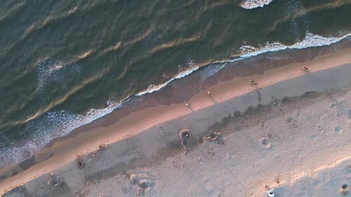 Beautiful flight in summer over the beach in Katwijk aan Zee. People are resting near the sea. House