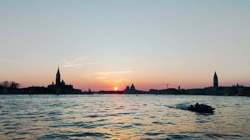 Sunset Over Venice With Bright Orange Sun And Boats In Slow Motion