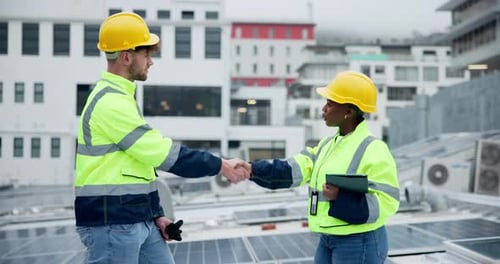 Employees, technician and solar panel with handshake at rooftop for partnership in green energy