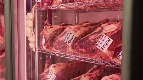 Close up dry aging cabinet with beef meat in cold storage.