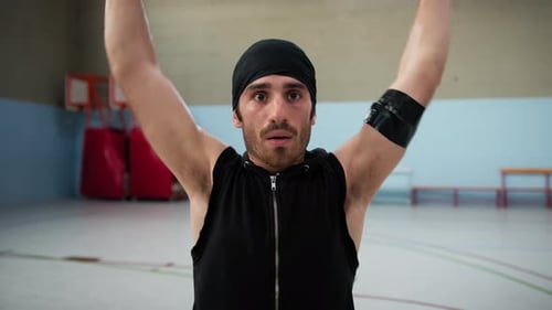 Athlete Moves Arms Biceps After Warming Up Basketball Court