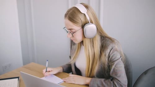 Young Woman Studying at Desk with Laptop