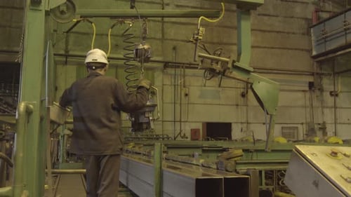 Industrial Worker Employed in a Factory Setting Contributing to Various Aspects of Production