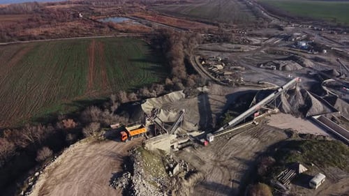 Quarry site with heavy machinery and mineral extraction process observed