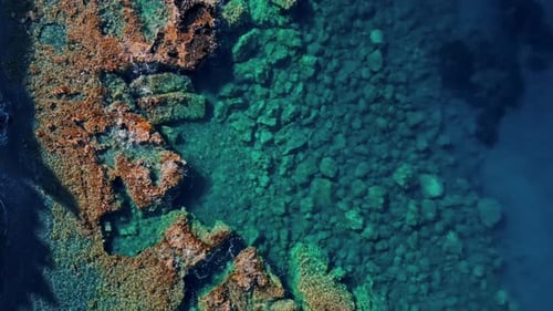 Aerial view of rocks in clear sea water, Greece.