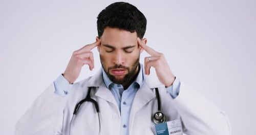 Headache, doctor or pain of man in studio with burnout, stress or medical mistake on white