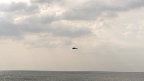Footage of an Airplane Over the Sea Cloudy