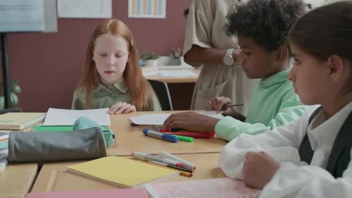 Children Studying at Desks in a Bright Classroom