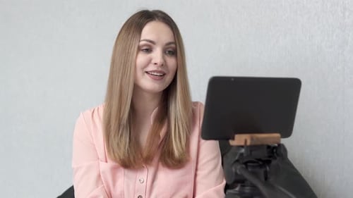 A geometry teacher conducts an online lesson with high school students via a tablet.
