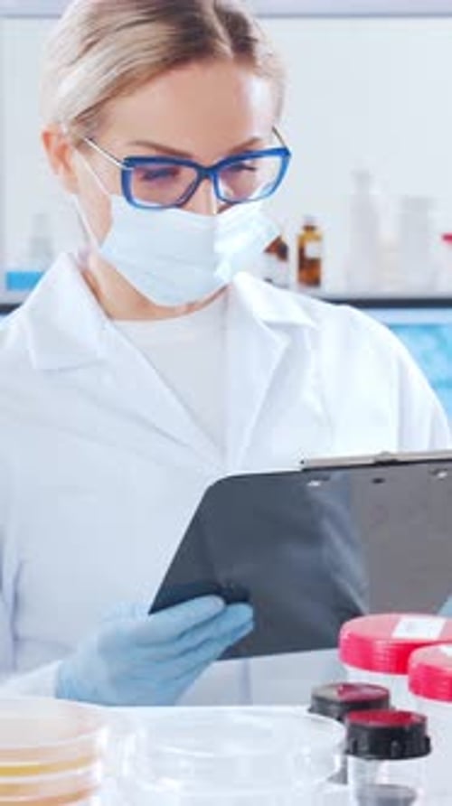Scientists Working in Laboratory Wearing Masks and Gloves