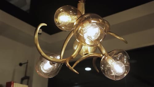 Modern Chandelier with Glowing Bulbs and Bronze Metal