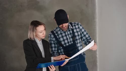 Woman and Contractor Review Home Renovation Project