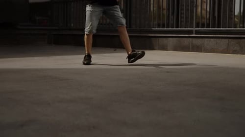 Young Man in Black Tshirt and Jeans Dance Hiphop in the City