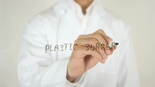 Doctor Writing Plastic Surgery on Glass