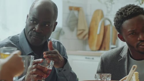 Friends Drink Wine at a Kitchen Table