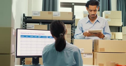 man hold tablet and girl partner wear formal shirt sit front desk computer meeting discuss inventory