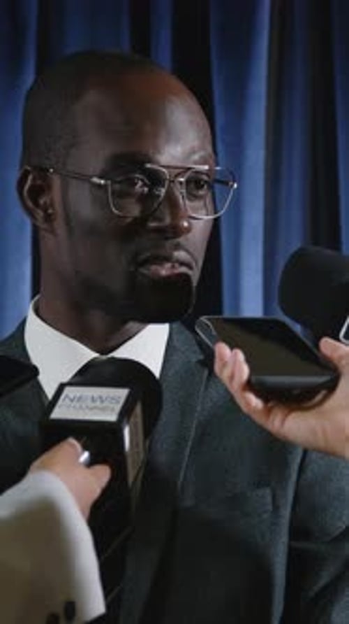 Man Giving Speech to Reporters at Conference