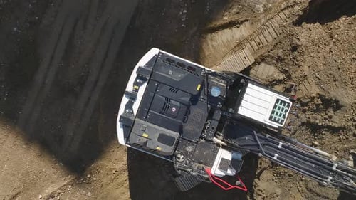 Scenic View in Excavators and Trucks at Construction Site
