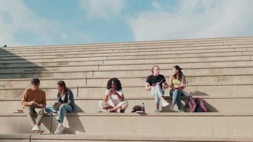 Students Studying Outdoors on Concrete Steps
