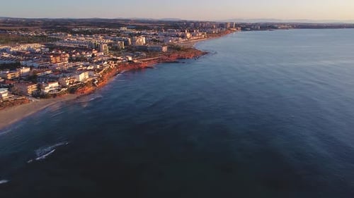 Aerial drone view of cityscape and coastline of Mil Palmeras beach and Pilar de la Horadada in Spain