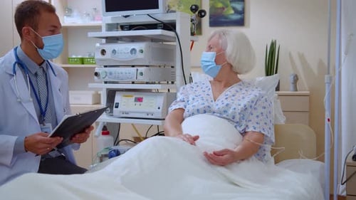 Caucasian Old Woman Staying in Hospital Welcoming Doctor Communicating About Coronavirus Disease