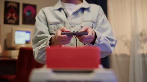Young Adult Playing Vintage Video Game At Home
