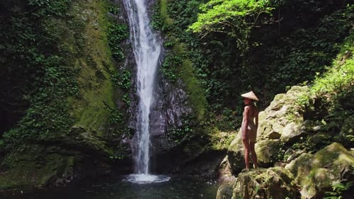 Woman Posing Near Forest Waterfall