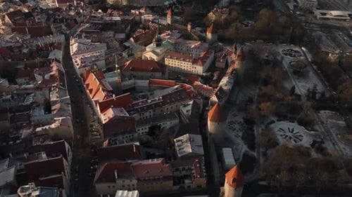 Top down aerial view over town walls of Tallinn during sunset - February 2023