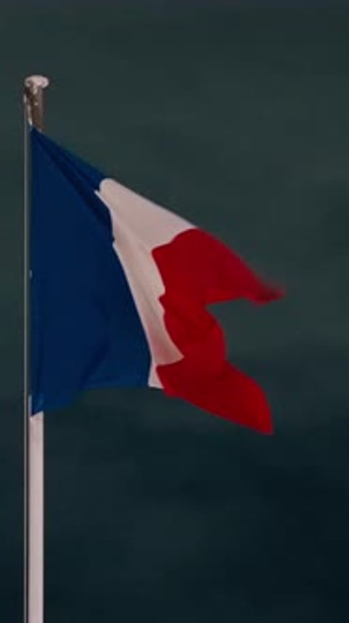 The French Flag Fluttering in the Wind at Dusk