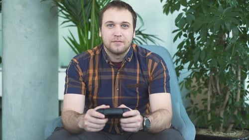 Young Man Playing Video Game in Living Room