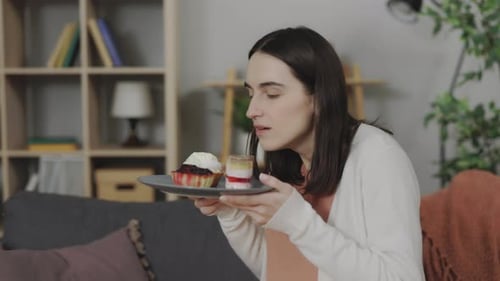 Woman Having Nausea While Smelling Sweets at Home